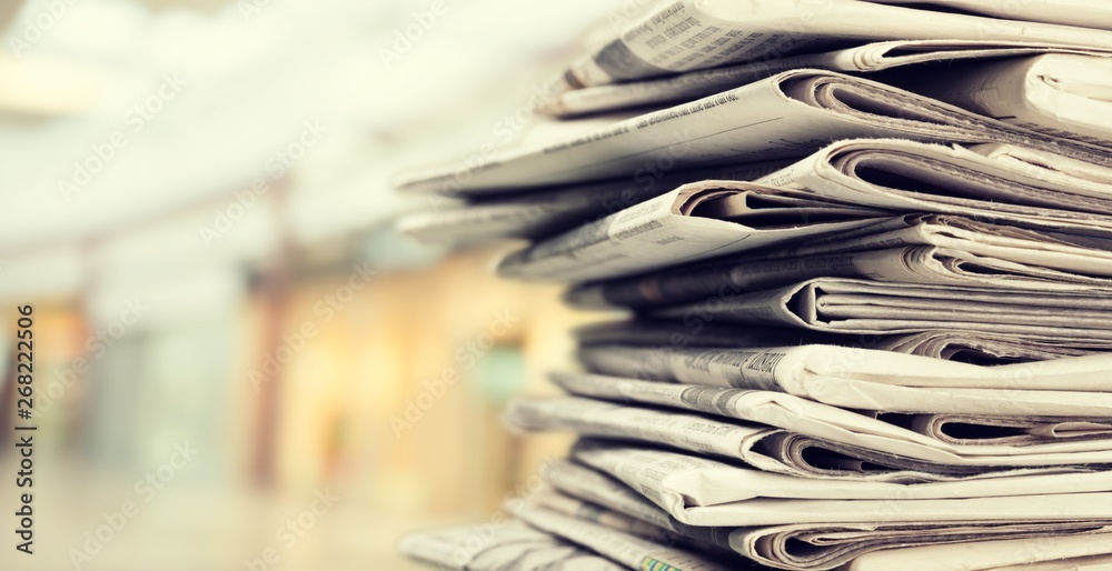 Pile of newspapers on white background