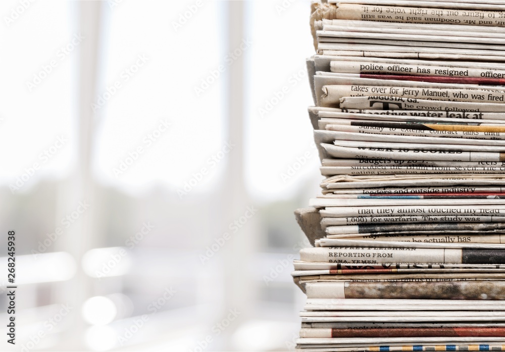 Pile of newspapers on white background