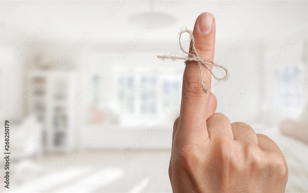 Rope bow on finger pointing  up on background