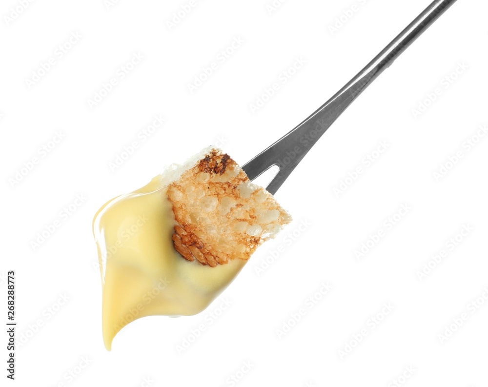 Fondue stick with cheese covered piece of bread on white background