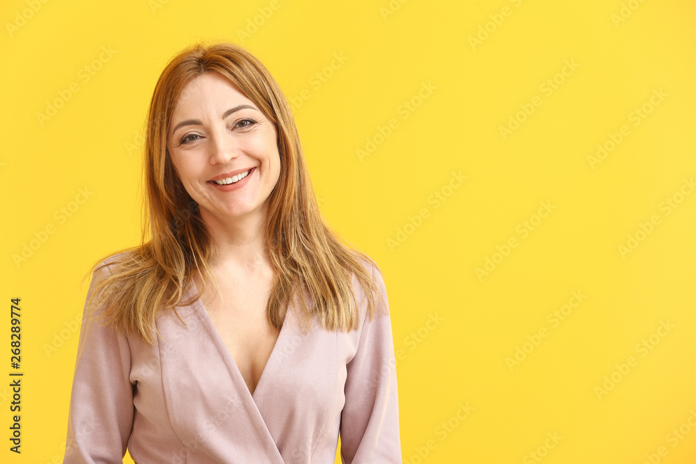 Portrait of mature woman on color background