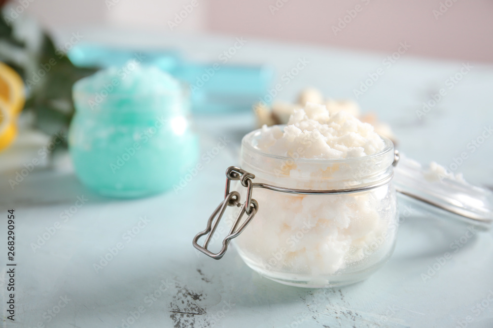 Jar with body scrub on table