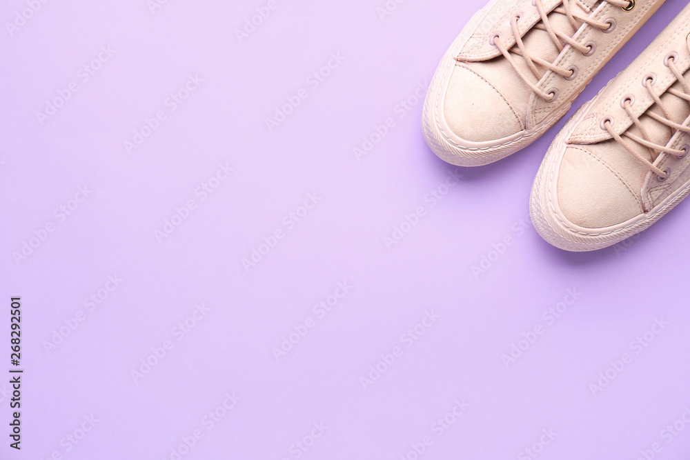 Pair of stylish casual shoes on color background