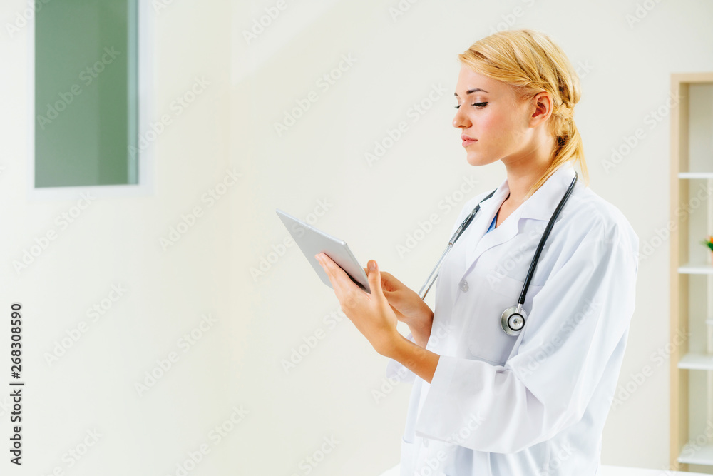 Young female doctor working in hospital office. Medical and healthcare concept.