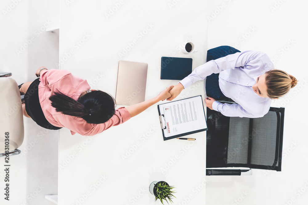 Two young business women in meeting at office table for job application and business agreement. Recr