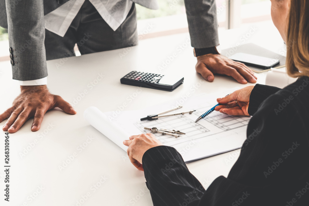 Architect and engineer working with construction drawing project on table in office. Architecture an