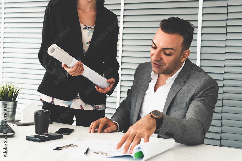 Businessman executive checking work while meeting discussion with businesswoman worker in modern wor