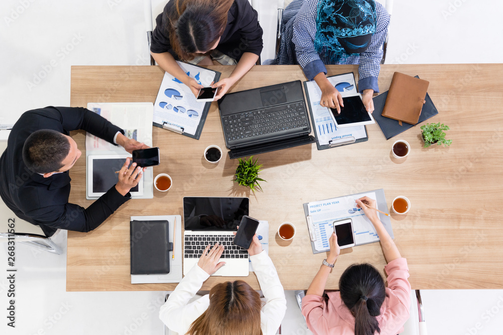 Top view of businessman executive in group meeting with other businessmen and businesswomen in moder