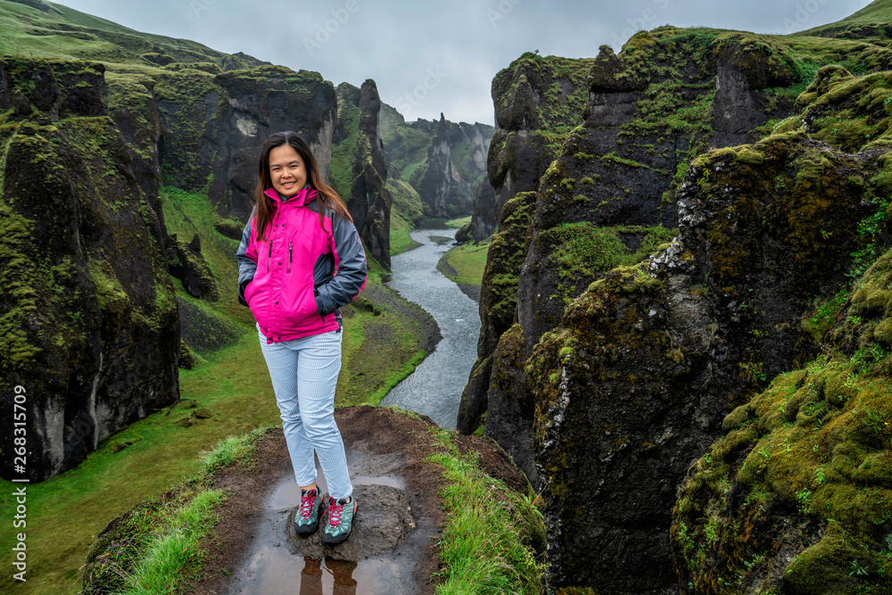 Woman traveller hike Fjadrargljufur in Iceland. Top tourism destination. Fjadrargljufur Canyon is a 