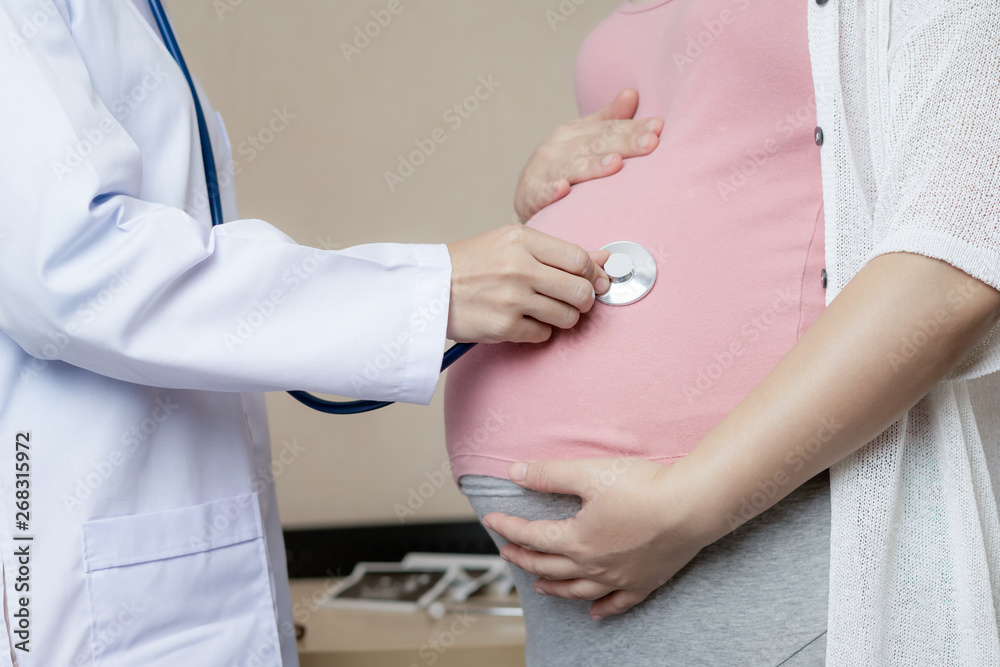 Happy pregnant woman visit gynecologist doctor at hospital or medical clinic for pregnancy consultan