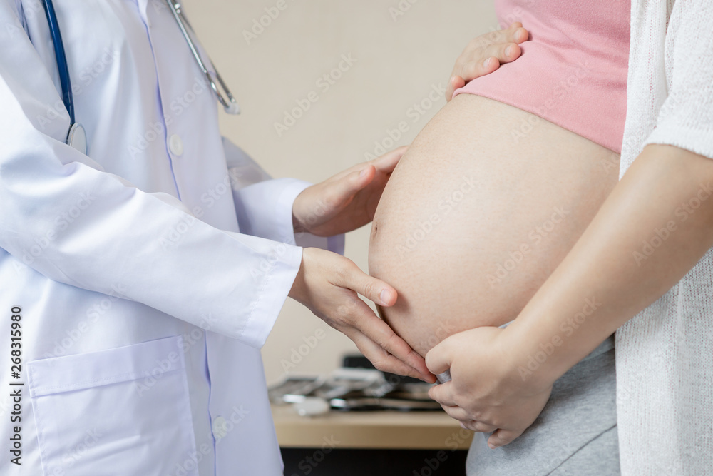 Happy pregnant woman visit gynecologist doctor at hospital or medical clinic for pregnancy consultan