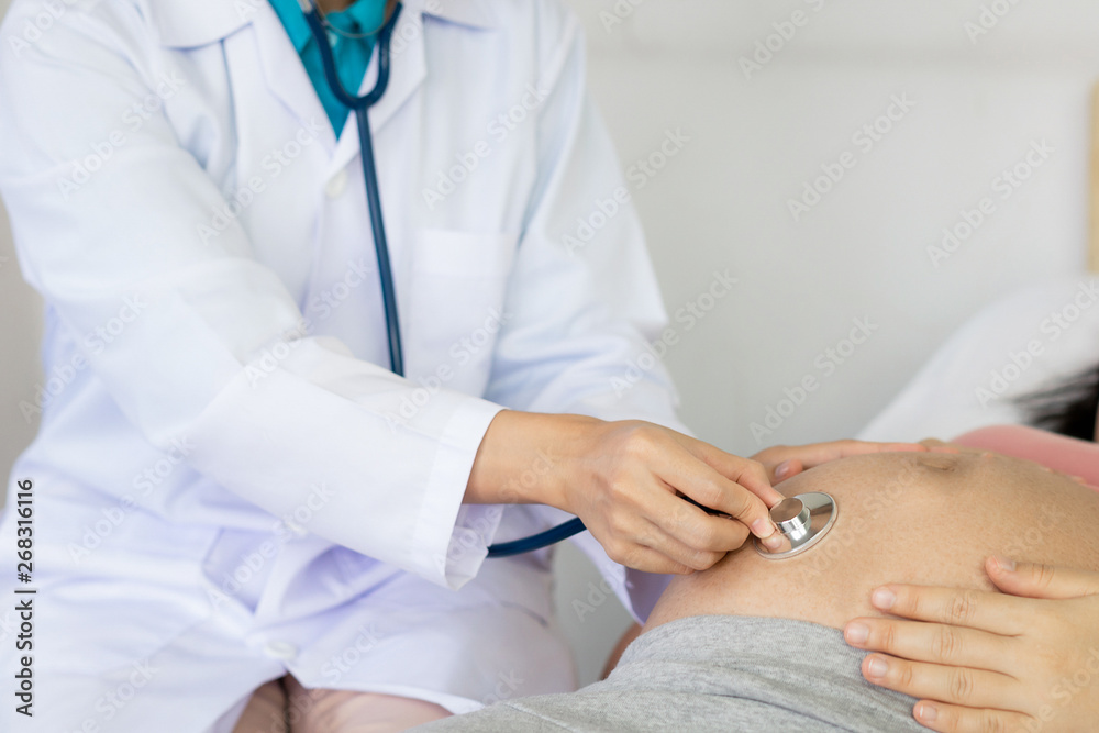 Happy pregnant woman visit gynecologist doctor at hospital or medical clinic for pregnancy consultan