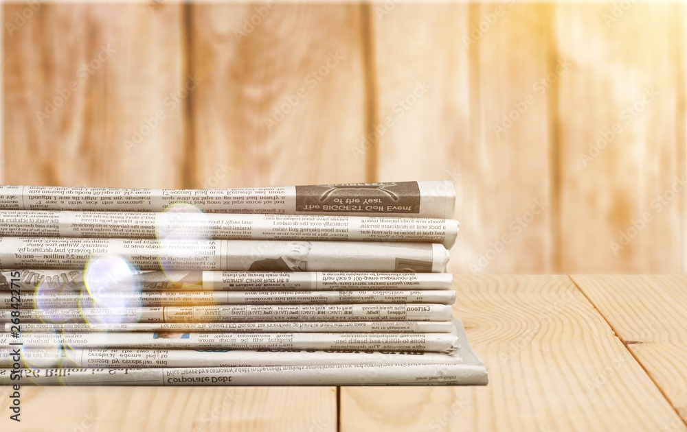 Pile of newspapers on white background