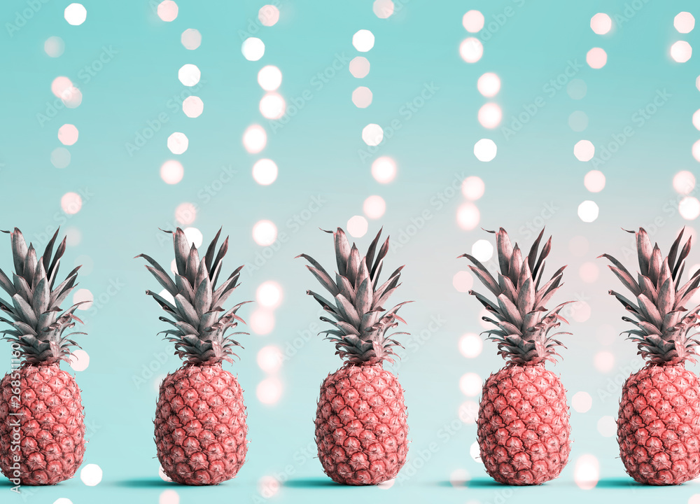 Many pineapples on a shiny light background