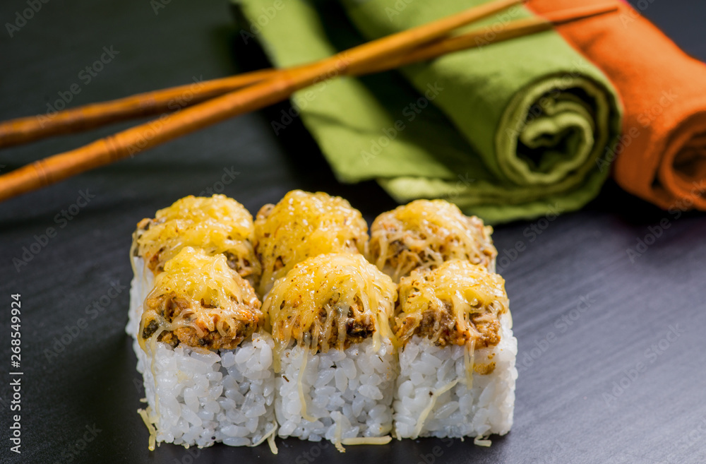 Japanese sushi and rolls on a black background