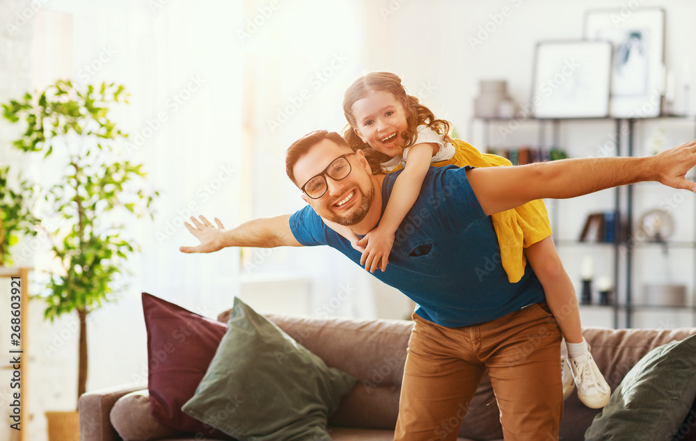 Fathers day. Happy family daughter hugs his dad  .