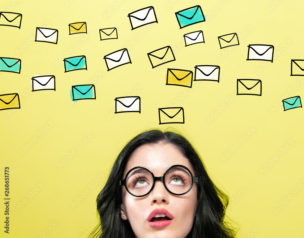 Many emails with young woman wearing eye glasses