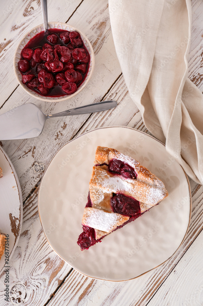 Tasty cherry pie on white wooden table