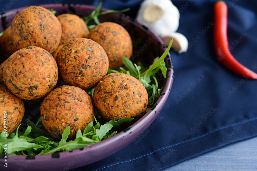 Plate with tasty falafel balls on table