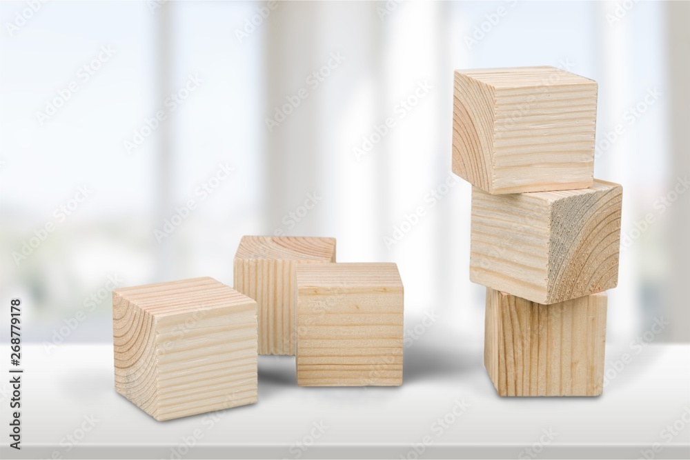 Wooden cubes on table background