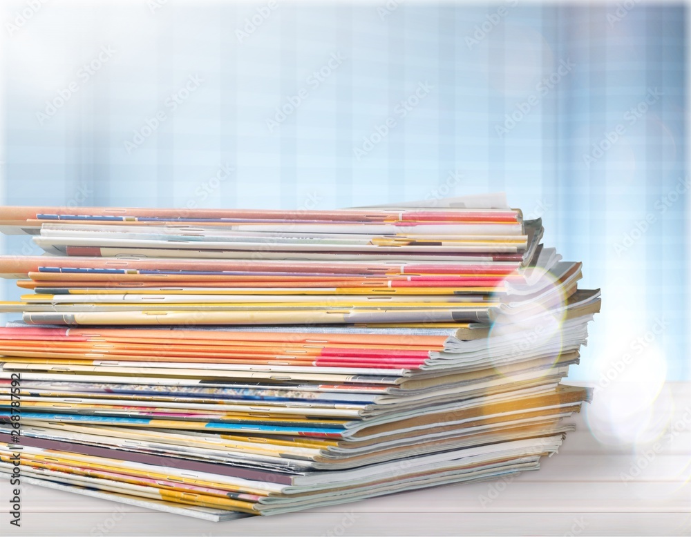 Pile of newspapers on white background