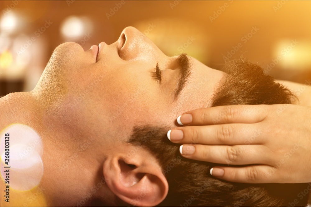 Young man relaxed in spa ,Closeup of a man having head massage