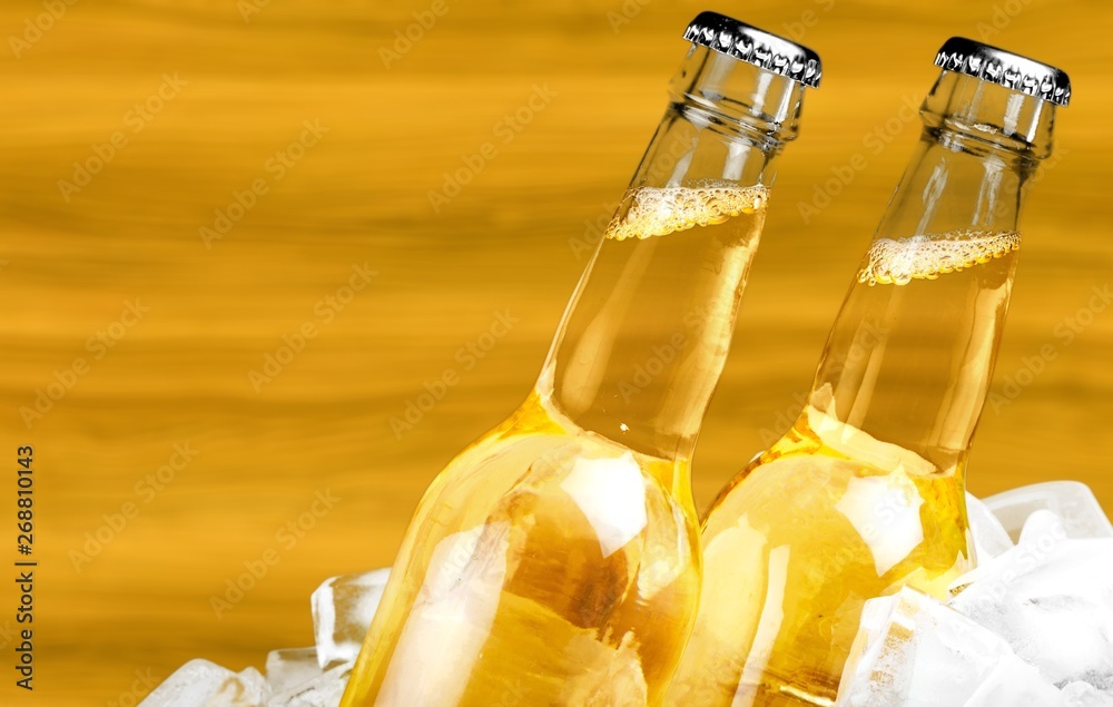 Bottles of cold and fresh beer with ice isolated on white