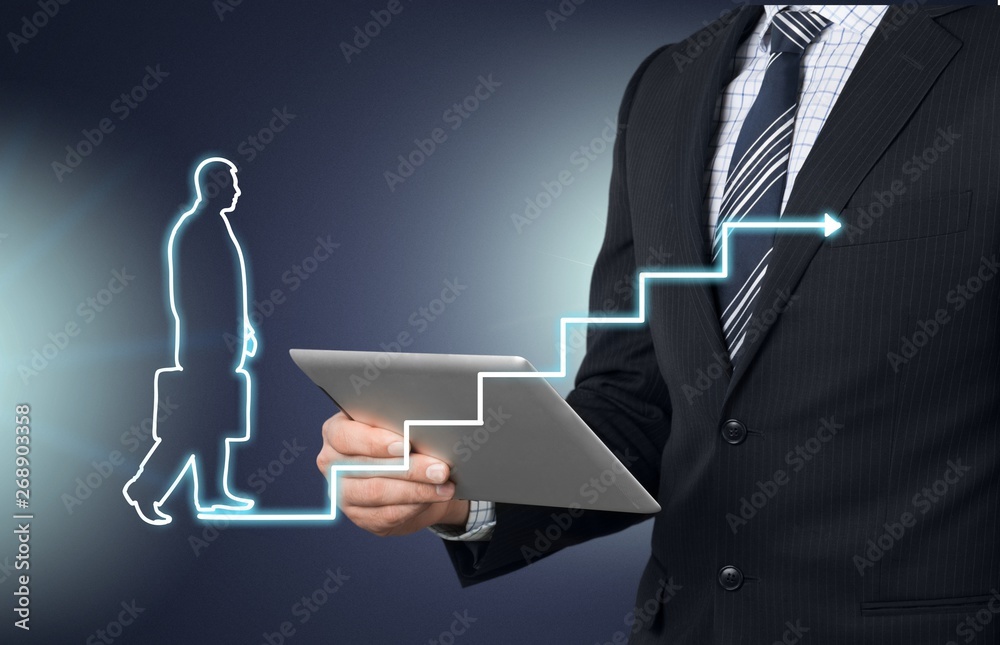 Businessman drawing graphics on background