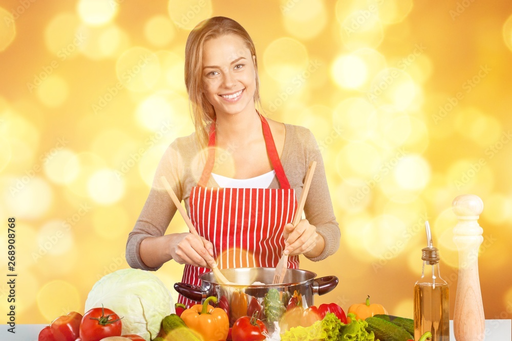 Young beautiful woman Cooking in kitchen