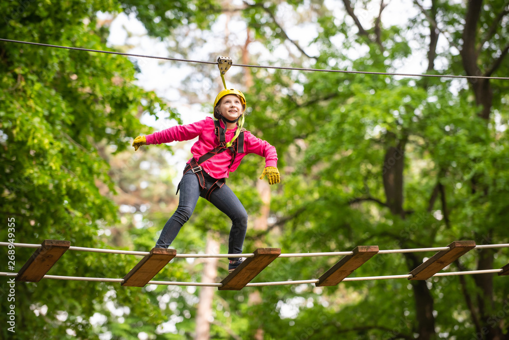 Artworks depict games at eco resort which includes flying fox or spider net. Children summer activit