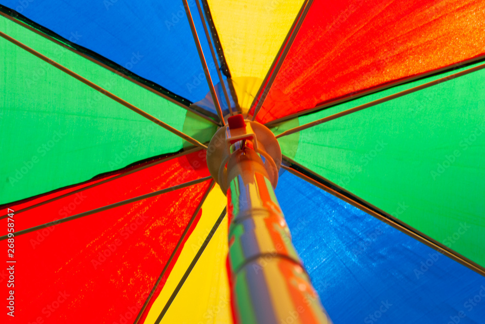 Looking up into the colorful sunshade - rainbow colors - summer feeling