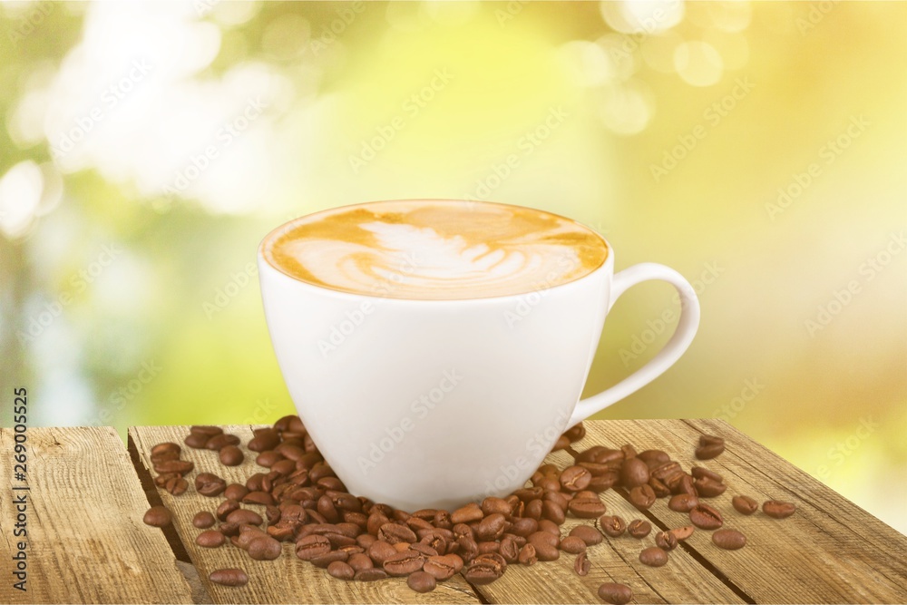 Coffee mug with cream and grains on the table