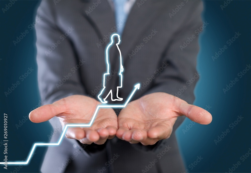 Businessman holding digital glowing graph with silhouette