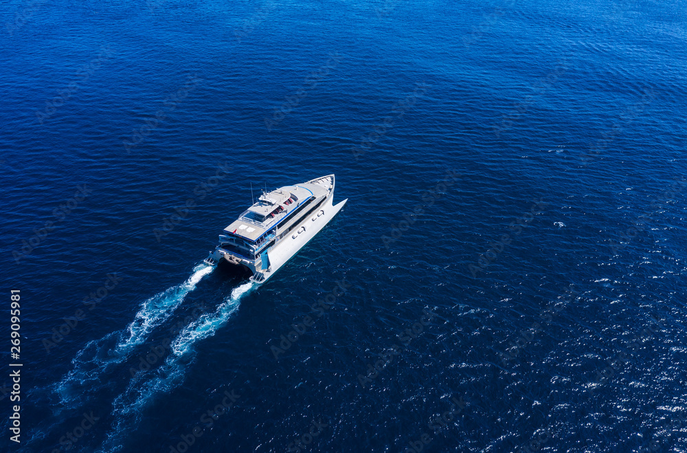 Aerial view of luxury floating cruise ship on transparent turquoise water at sunny day. Summer seasc