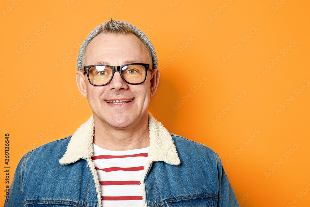 Stylish middle-aged man on color background