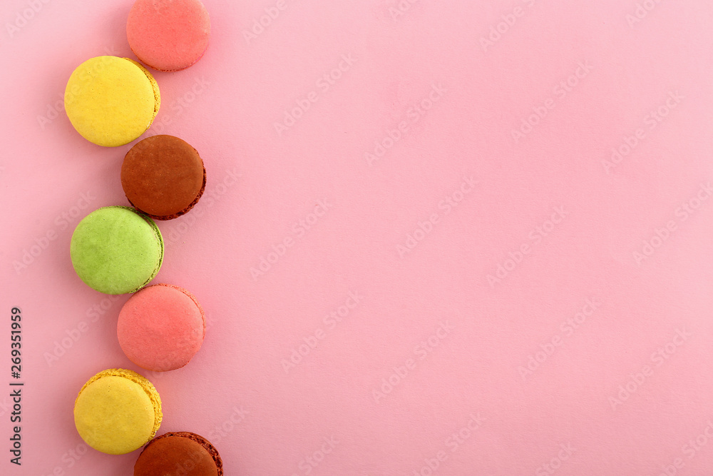 Tasty macarons on color background