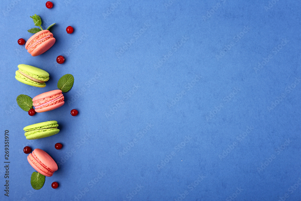 Tasty macarons on color background