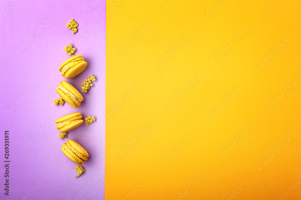 Tasty macarons on color background