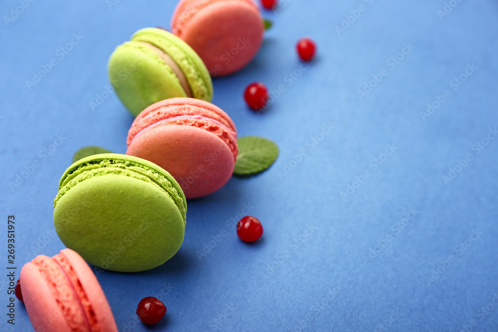 Tasty macarons on color background