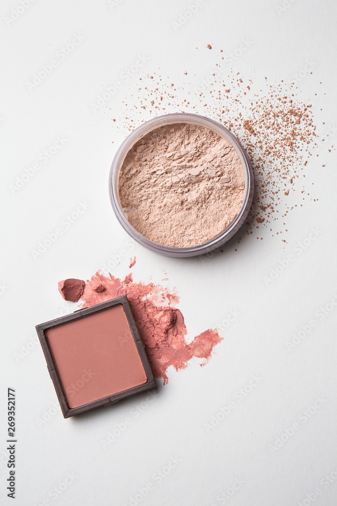 Blusher and facial powder on light background