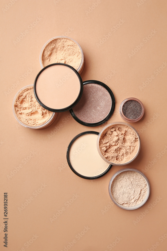 Different facial powder on color background