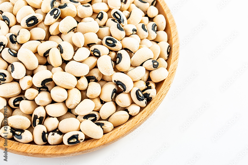 Dried rice bean beans on a saucer on a white background