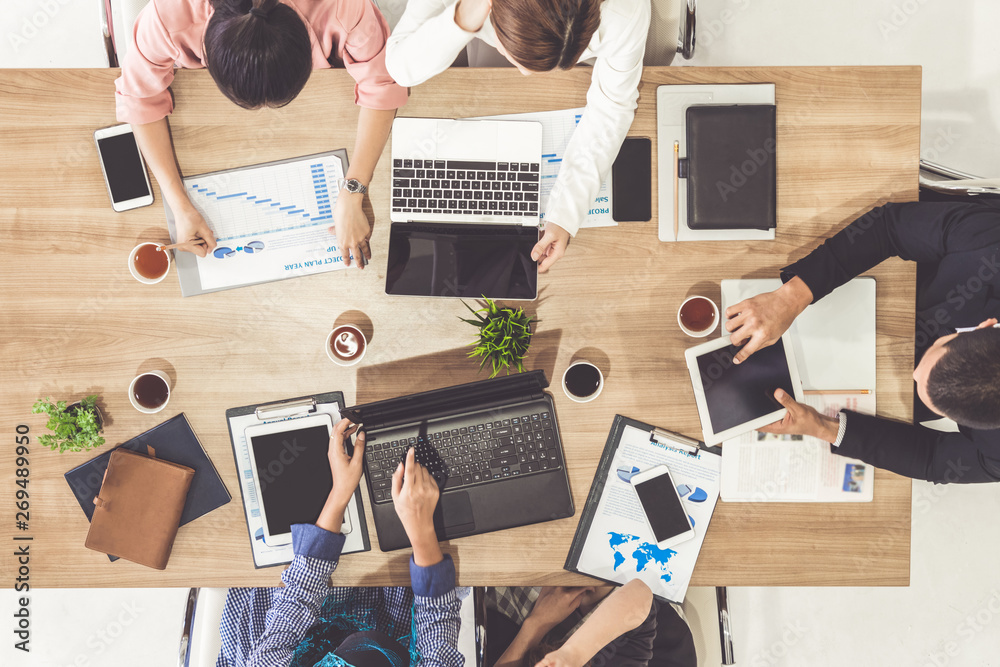 Top view of businessman executive in group meeting with other businessmen and businesswomen in moder