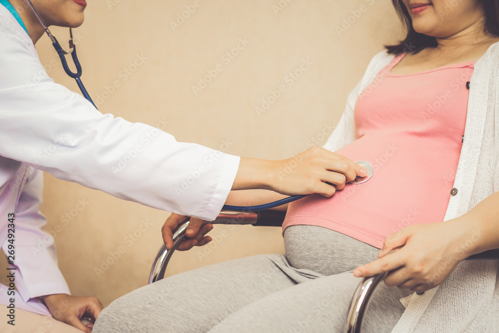 Happy pregnant woman visit gynecologist doctor at hospital or medical clinic for pregnancy consultan