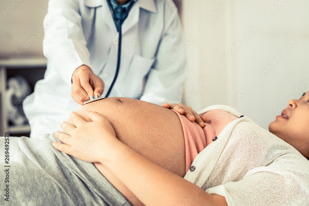 Happy pregnant woman visit gynecologist doctor at hospital or medical clinic for pregnancy consultan