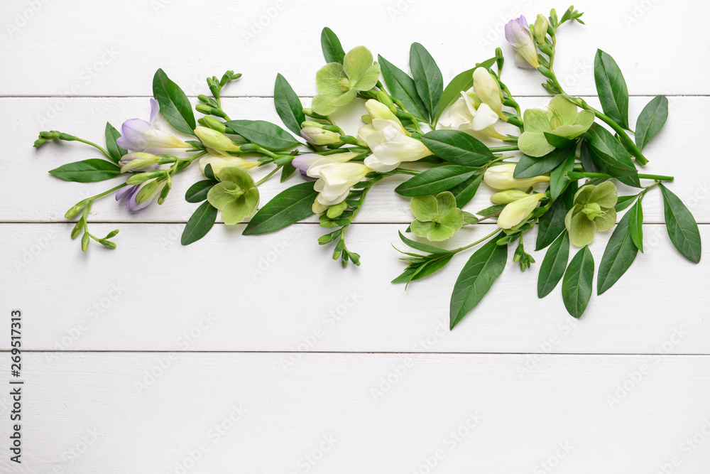 Beautiful flowers on white wooden background