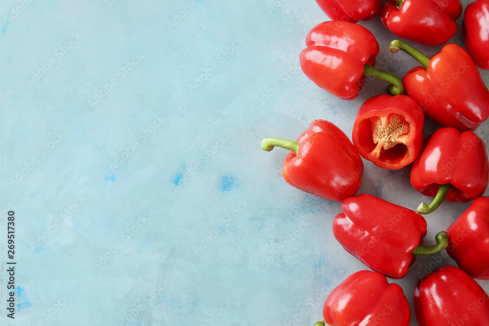 Ripe red peppers on color background