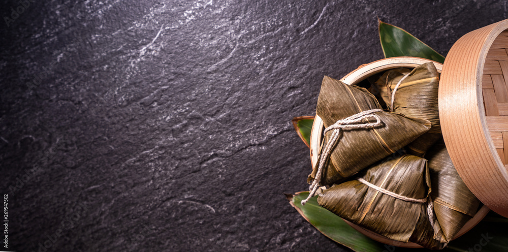 Zongzi, delicious steamed rice dumplings in steamer in black background for dragon boat duanwu festi