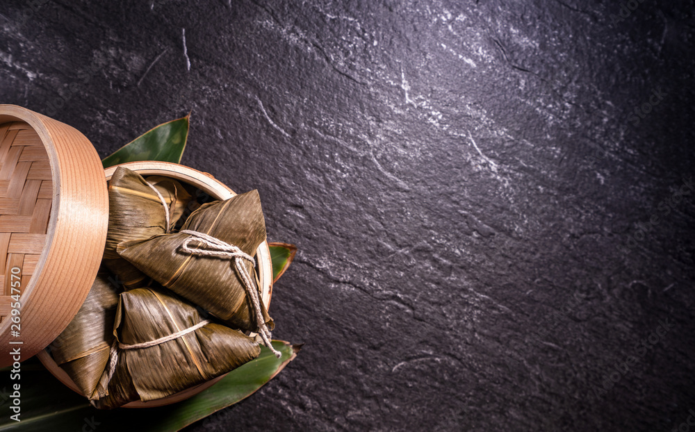 Zongzi, delicious steamed rice dumplings in steamer in black background for dragon boat duanwu festi