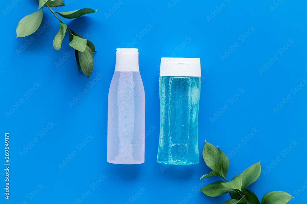 mycelial water, lotion for skin care and plant on blue background flat lay space for text